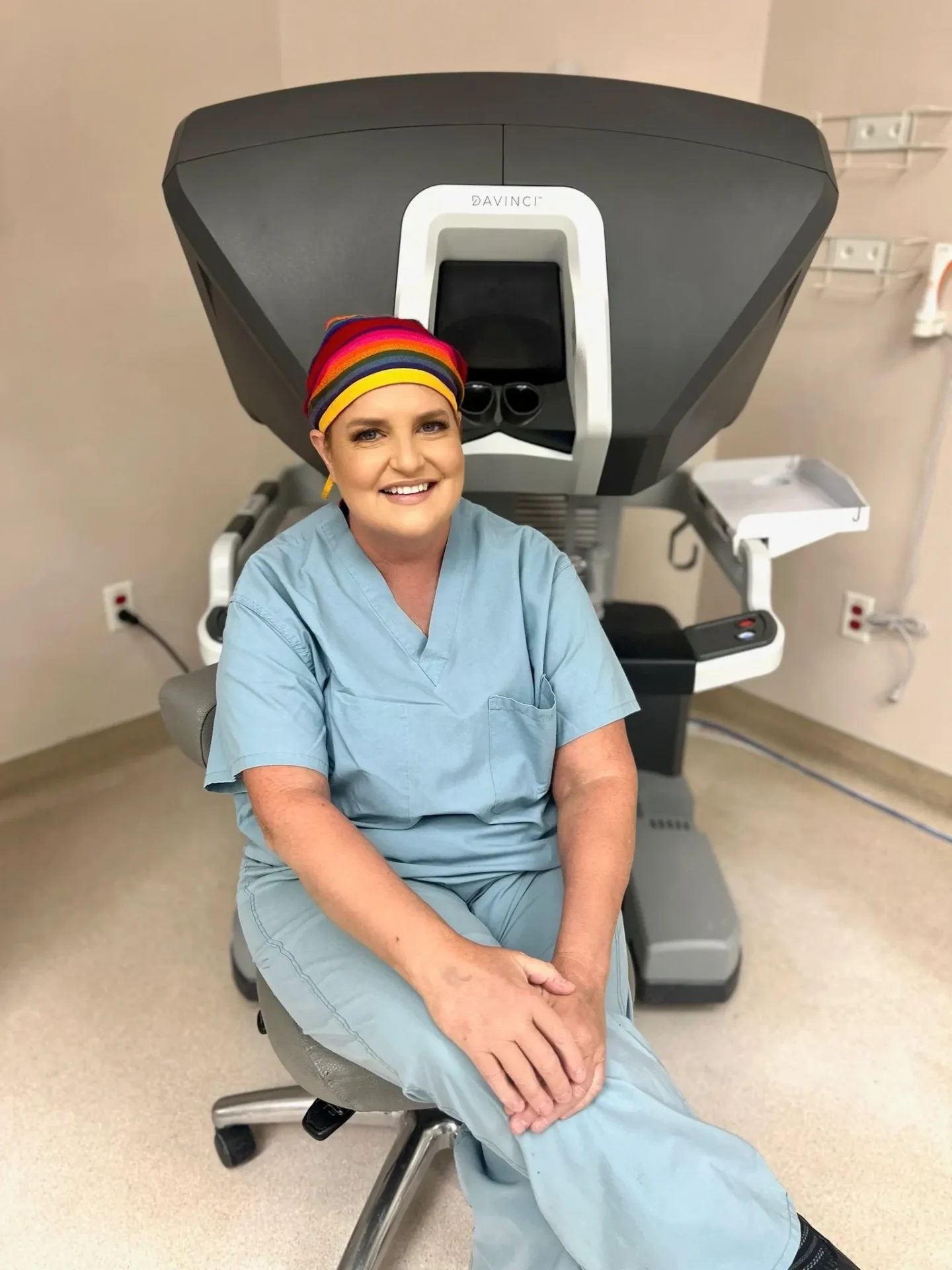 A woman sitting on top of a chair in an operating room.