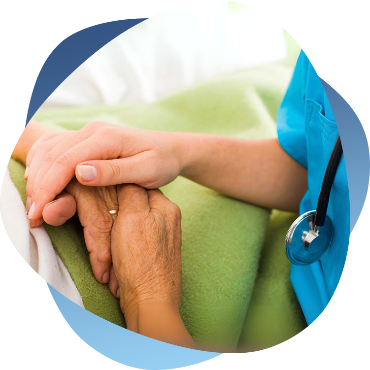 A nurse holding the hand of an elderly patient.